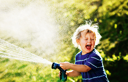 Boy playing with hose